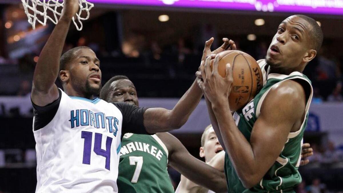 Khris Middleton of the Bucks grabs a rebound against the Hornets’ Michael Kidd-Gilchrist during the first half Tuesday at the Spectrum Center in Charlotte.