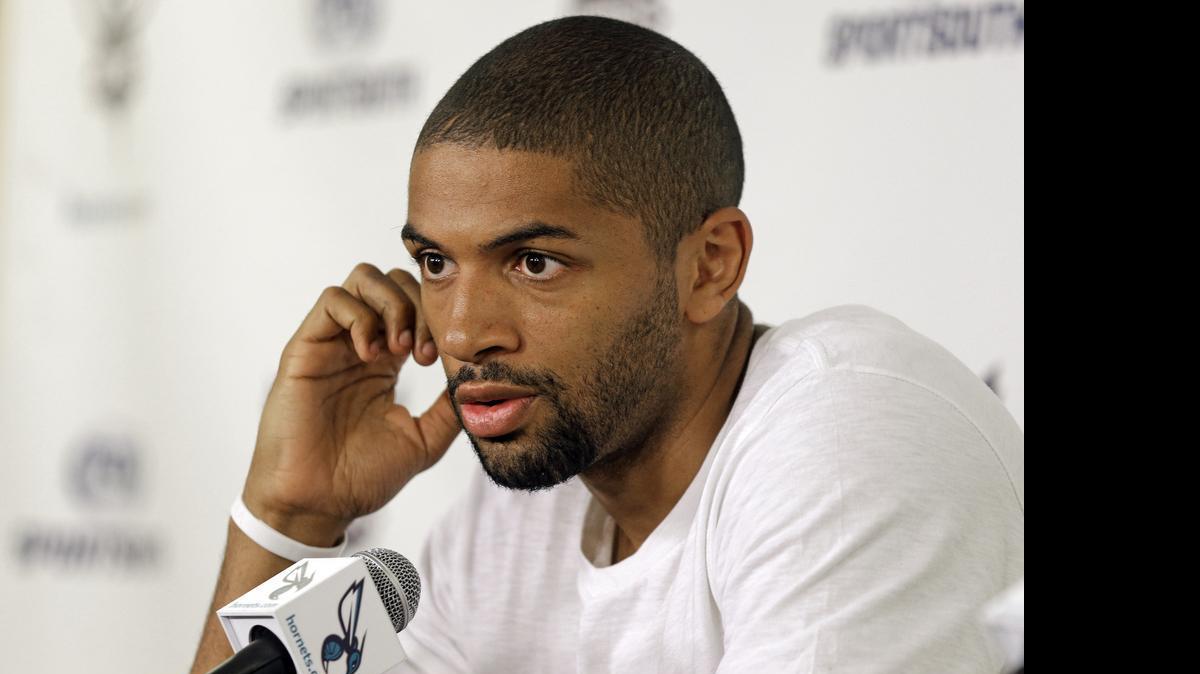 
Charlotte Hornets' newly acquired player Nicolas Batum answers a question during a new conference Friday Time Warner Cable Arena. 
