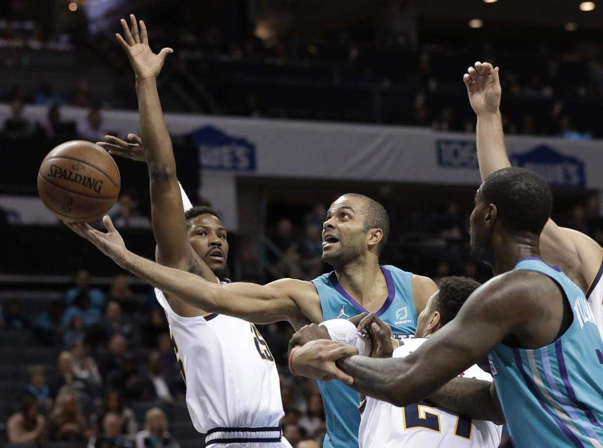 Charlotte Hornets’ Tony Parker, center, drives past Denver Nuggets’ Malik Beasley, left, in the first half of Friday’s NBA game at Spectrum Center. Parker came off the bench to score 19 points and added four assists.