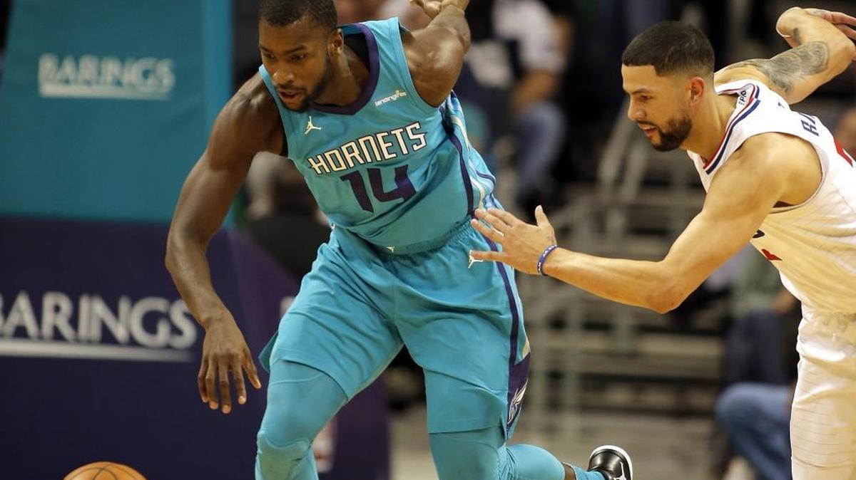 Charlotte Hornets' Michael Kidd-Gilchrist, left, gets control of the ball after slapping it away from Los Angeles Clippers guard Austin Rivers during the first half of Saturday night’s NBA game at the Spectrum Center.