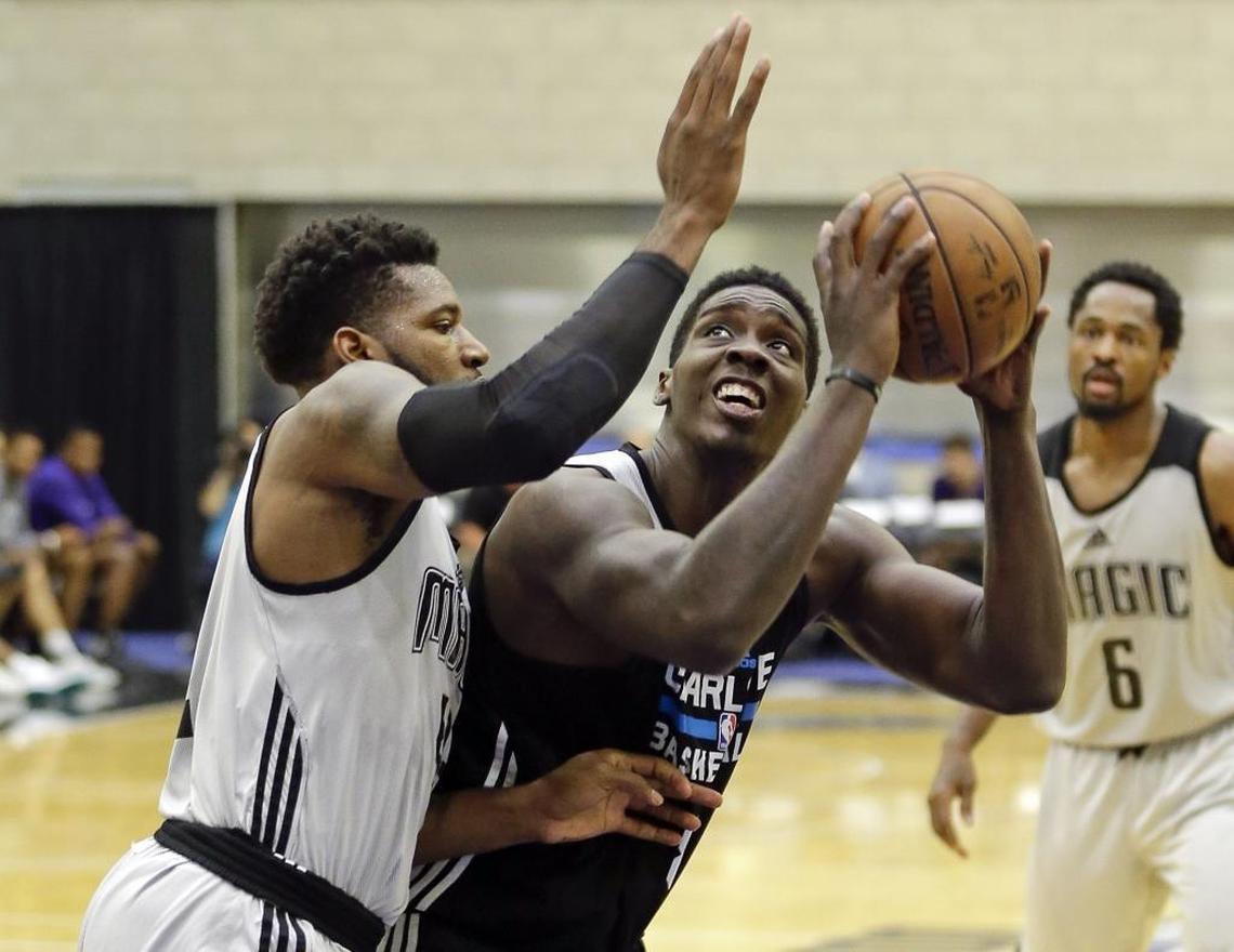 Johnny O'Bryant (with ball) looks to score for the Charlotte Hornets summer-league team, last month in Orlando, Fla. O’Bryant’s salary for next season – about $1.5 million – is now guaranteed.