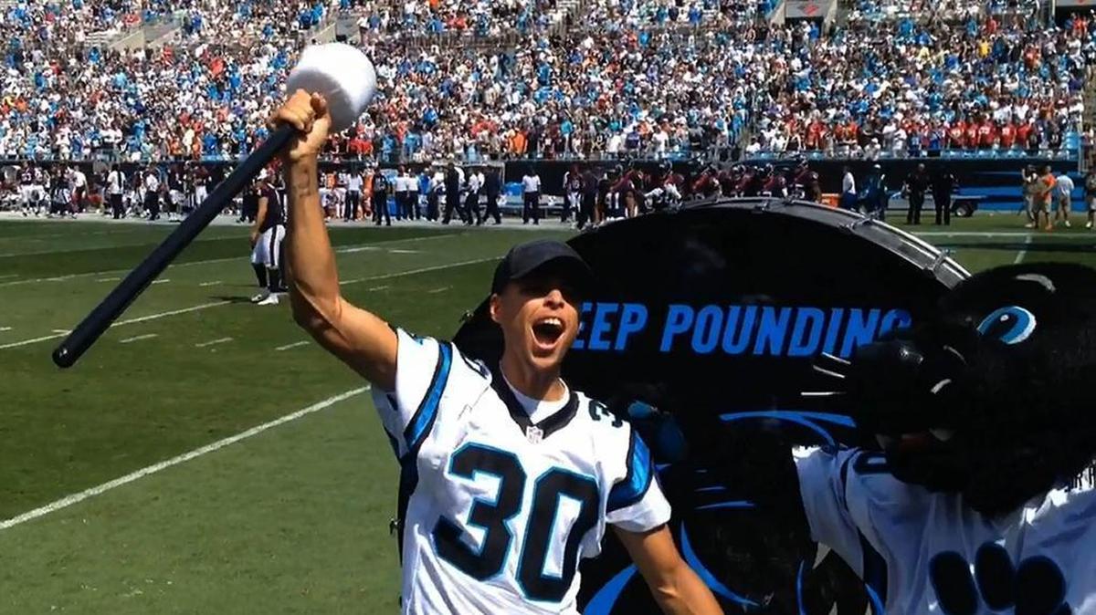 NBA champion and MVP Stephen Curry rallies Carolina Panthers fans after hitting the “Keep Pounding” drum prior to a 2015 game against the Houston Texans at Bank of America Stadium.