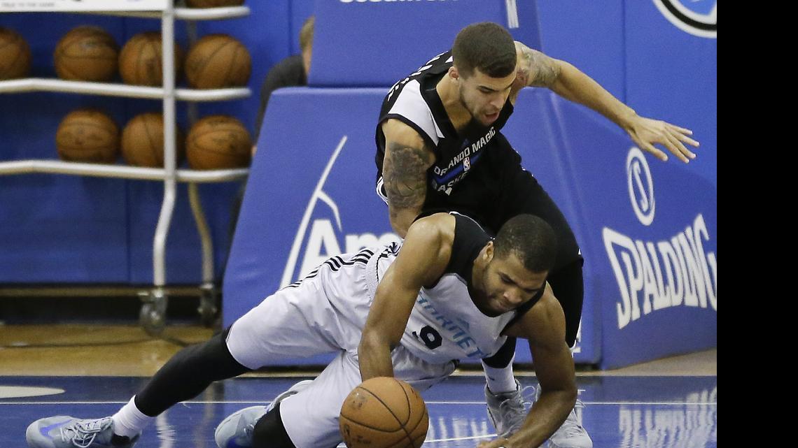 
Charlotte Hornets guard Aaron Harrison, lower left, and Orlando’s Scottie Wilbekin scramble for a loose ball during the second half of an NBA summer league basketball game, Wednesday, July 8, 2015, in Orlando, Fla.
