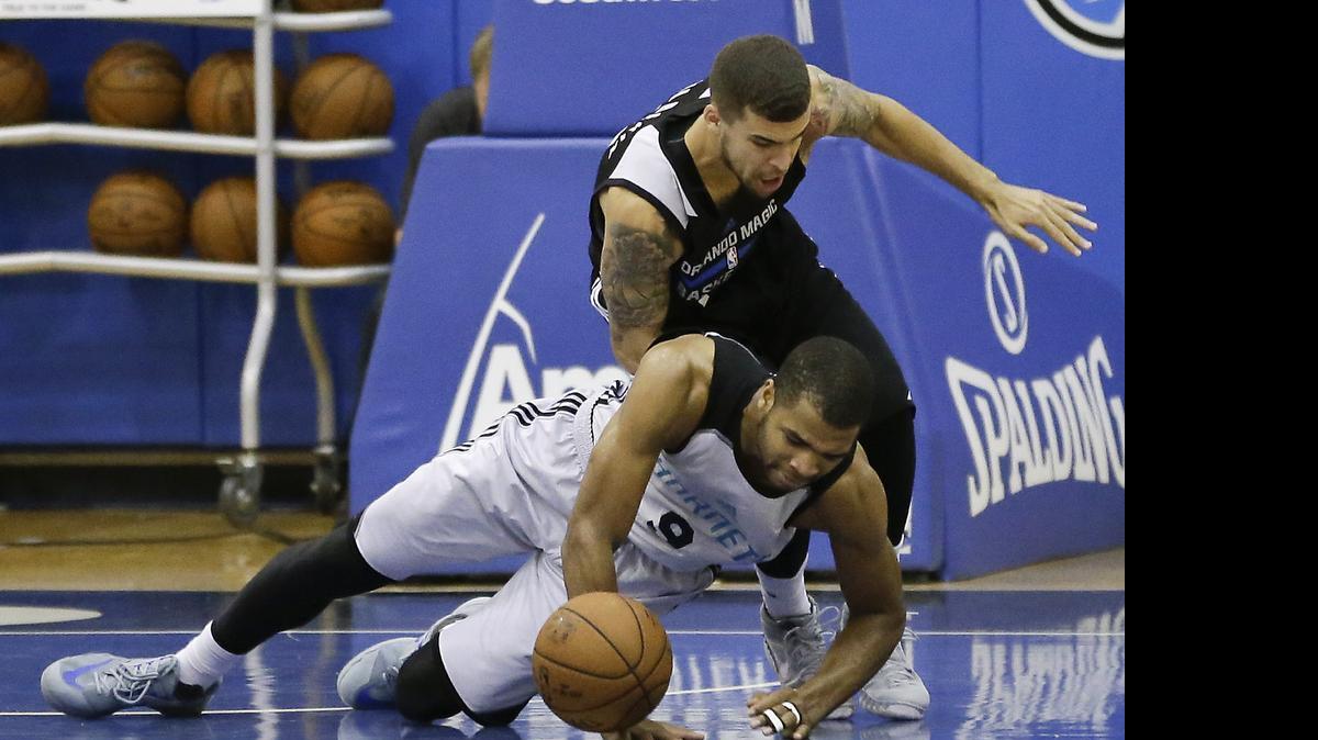 
Charlotte Hornets guard Aaron Harrison, lower left, and Orlando’s Scottie Wilbekin scramble for a loose ball during the second half of an NBA summer league basketball game, Wednesday, July 8, 2015, in Orlando, Fla.
