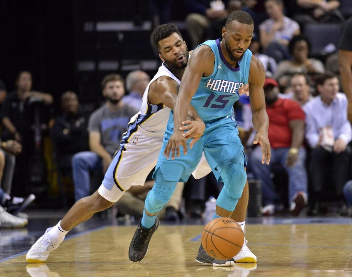Charlotte Hornets guard Kemba Walker (15) controls the ball against Memphis Grizzlies guard Andrew Harrison in the second half of Monday’s game in Memphis, Tenn.