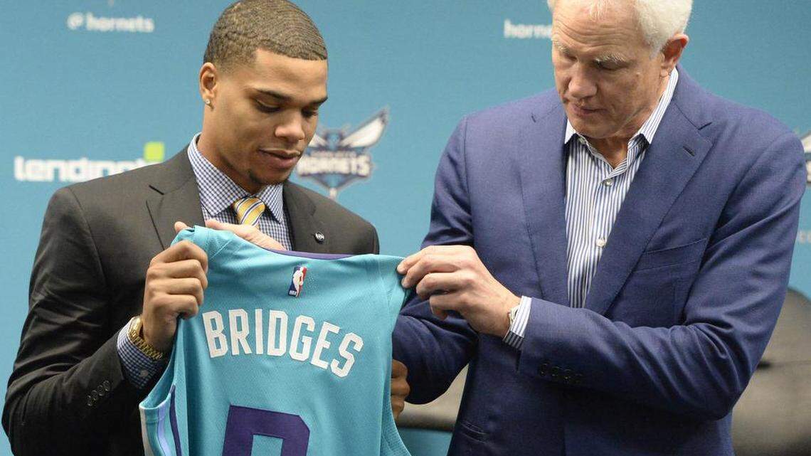 New Charlotte Hornets rookie Miles Bridges (left) shows off his first NBA jersey, with general manager Mitch Kupchak.