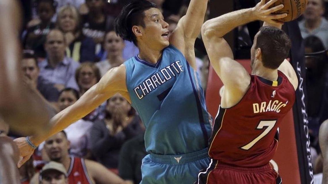 Miami Heat guard Goran Dragic (7) shoots as Charlotte Hornets guard Jeremy Lin, left, defends during Thursday’s game in Miami.