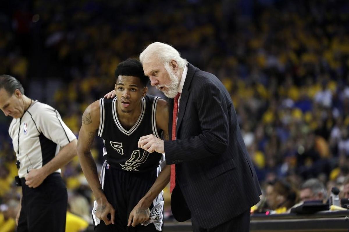 San Antonio Spurs rookie Dejounte Murray (left) takes direction from coach Gregg Popovich. Murray made two starts in Spurs playoff games.
