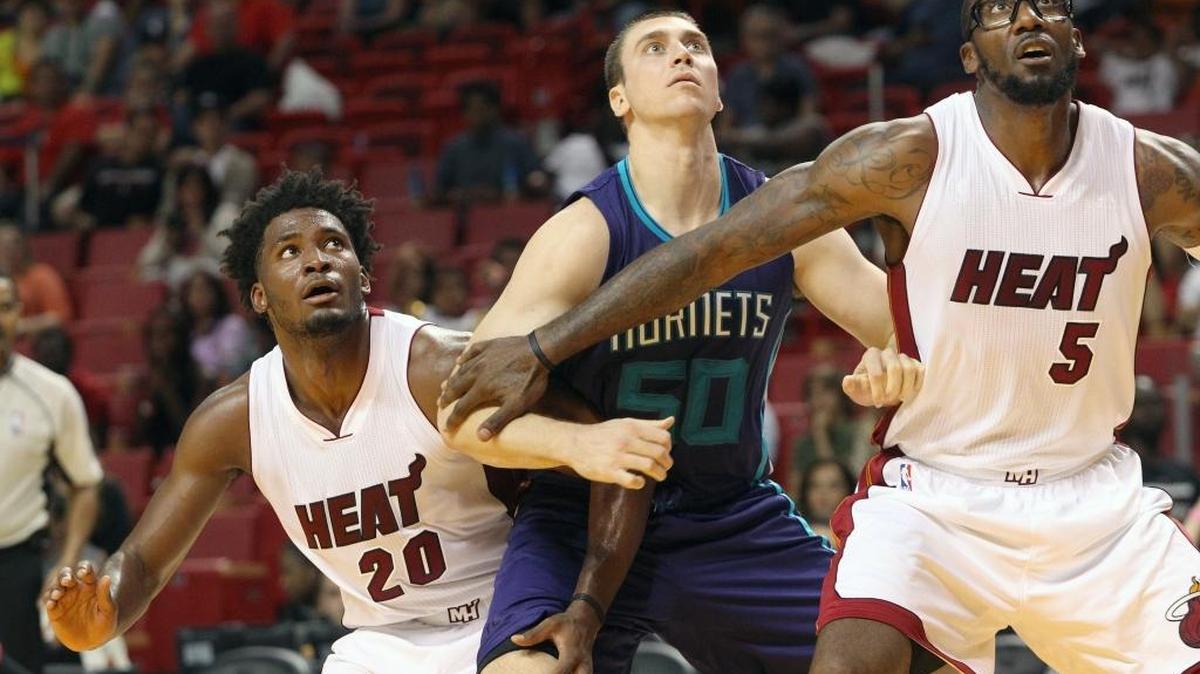 
Miami Heat player Amar'e Stoudemire (right) and Miami Heat player Justise Winslow (left) surround Charlotte Hornets player Tyler Hansbrough (center) in the fourth quarter during a pre season game Miami Heat against Charlotte Hornets on Sunday, October 4,2015 at the AmericanAirlines Arena in Miami. 
