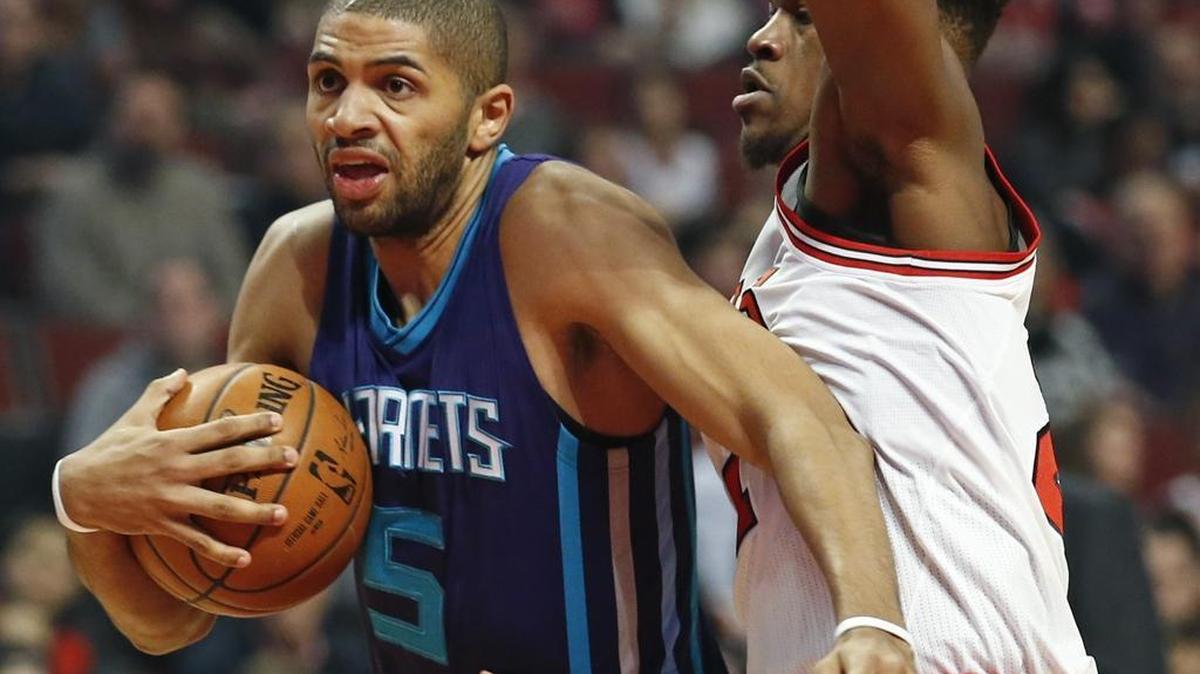 Charlotte Hornets guard Nicolas Batum, left, said his 28 points were a statement to fellow Frenchmen to stay strong in face of Friday’s attacks in Paris.