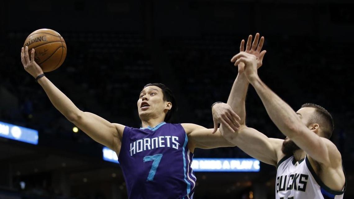 Charlotte Hornets' Jeremy Lin (7) shoots past Milwaukee Bucks' Miles Plumlee during the first half of an NBA basketball game Saturday in Milwaukee.