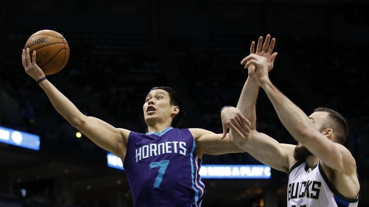 Charlotte Hornets' Jeremy Lin (7) shoots past Milwaukee Bucks' Miles Plumlee during the first half of an NBA basketball game Saturday in Milwaukee.