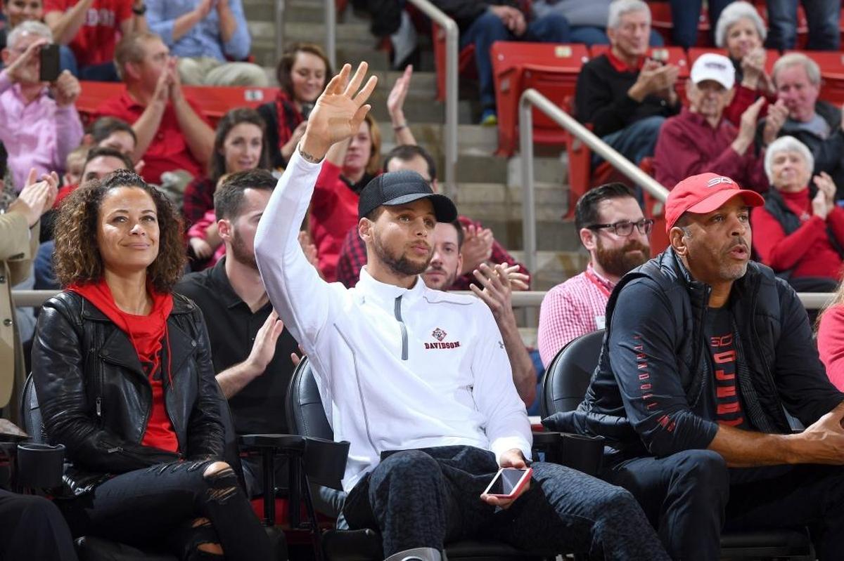 Golden State Warriors point guard Stephen Curry, the former Davidson All-American, waves to a cheering Davidson crowd Tuesday night at Belk Arena, where the Wildcats beat VMI. The NBA All-Star was joined by his parents, Sonya and Dell Curry.