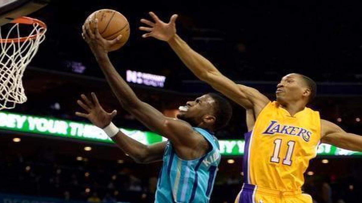 
Charlotte Hornets forward Michael Kidd-Gilchrist  drives to the basket past the Los Angeles Lakers’ Wesley Johnson  during the first half Tuesday at Time Warner Cable Arena.
