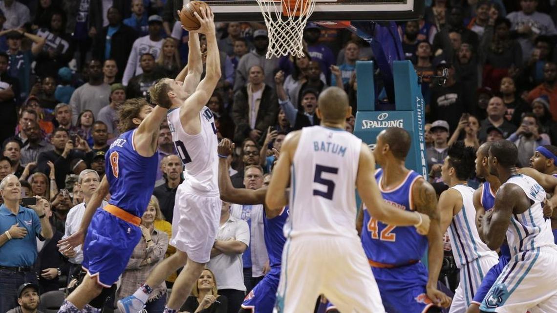Charlotte Hornets' Cody Zeller (40) drives for the game-winning basket past New York Knicks' Robin Lopez (8) during the second half of Wednesday’s game in Charlotte. The Hornets won 95-93.