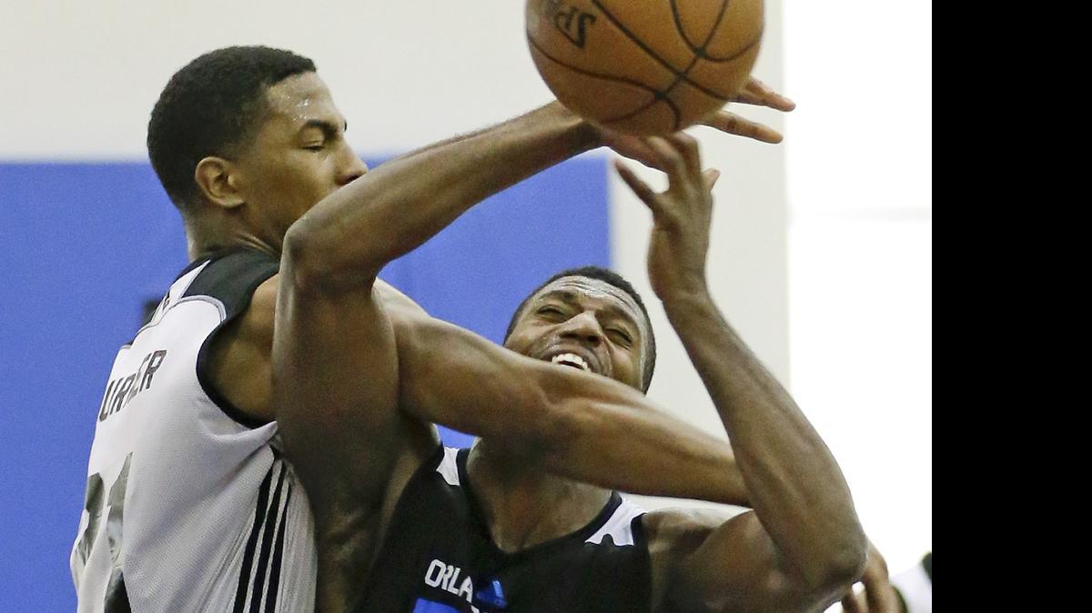 
Charlotte Hornets' Ralston Turner, left, fouls Orlando Magic White's Melvin Ejim as he tries to block a shot during the second half of an NBA summer league basketball game, Wednesday, July 8, 2015, in Orlando, Fla.
