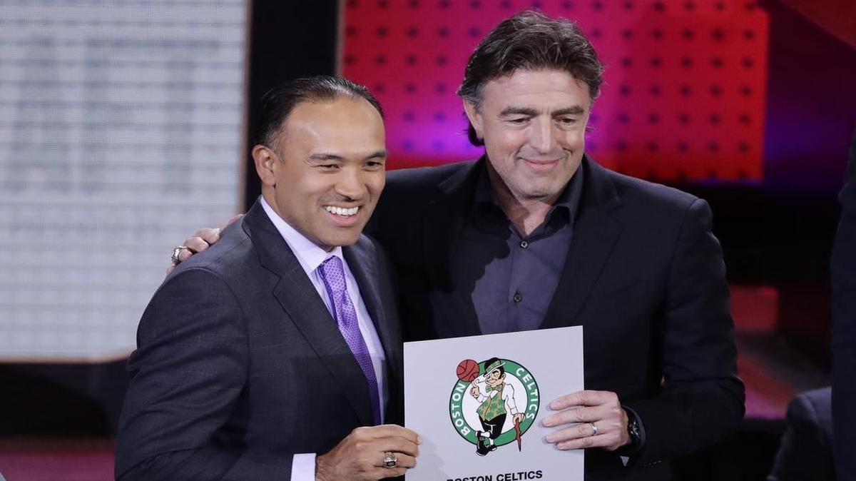 NBA Deputy Commissioner Mark Tatum, left, poses with Boston Celtics co-owner Wyc Grousbeck after the Celtics won the first pick in the draft.