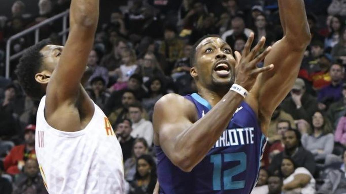 Charlotte Hornets center Dwight Howard, right, scored 33 points with 12 rebounds, both game highs, against his old team in Thursday’s 129-117 win at Atlanta.