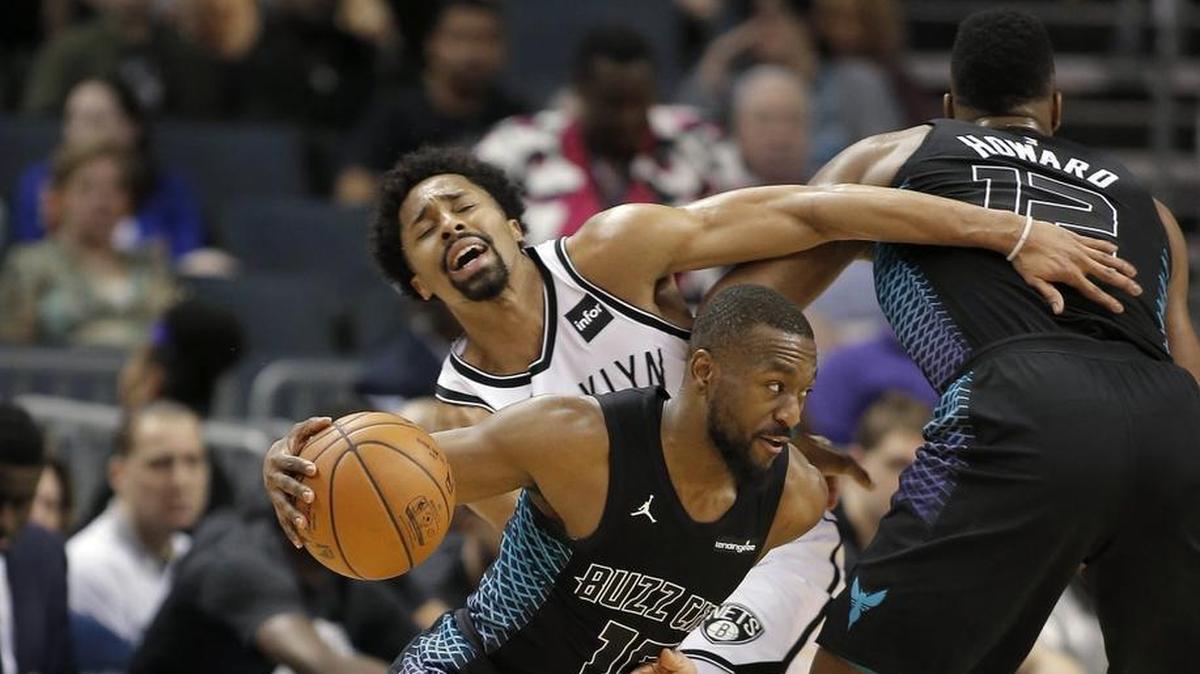 The Charlotte Hornets’ Kemba Walker (15) drives through a pick by teammate Dwight Howard in Thursday’s home game against the Brooklyn Nets.