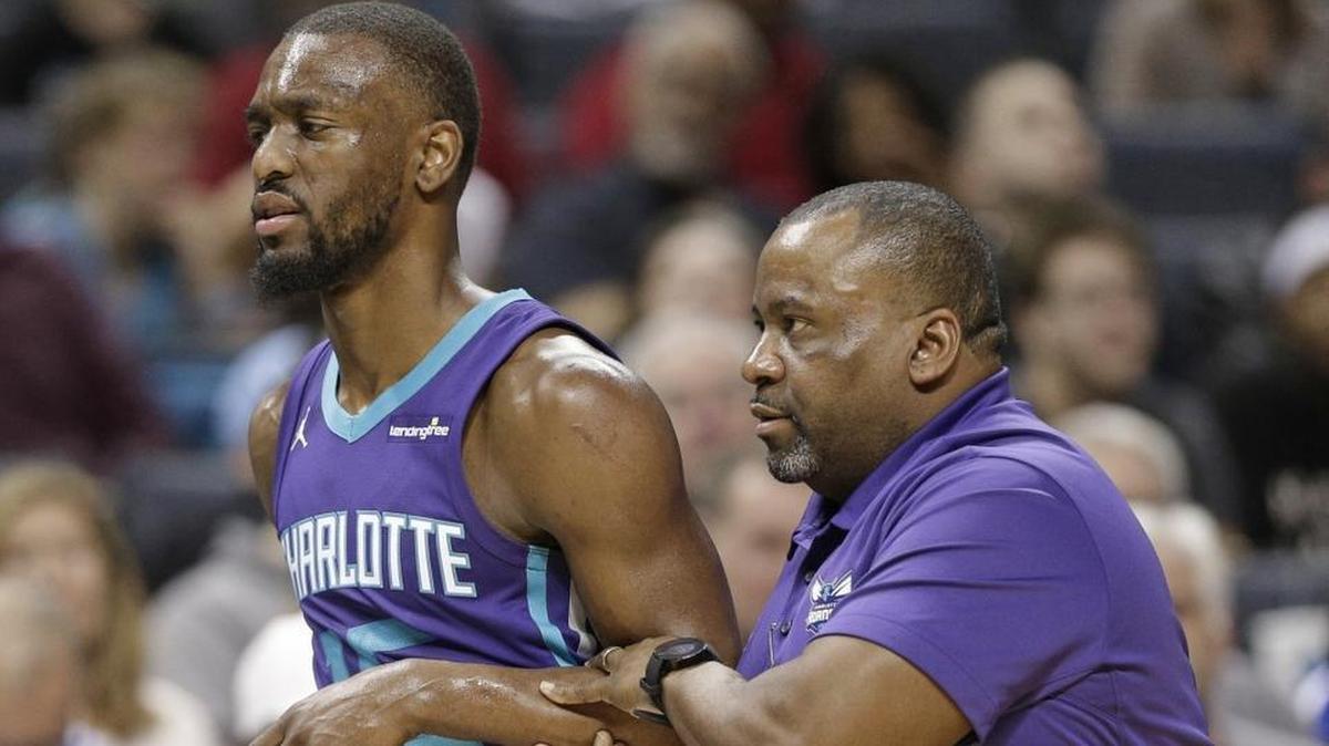 Charlotte Hornets guard Kemba Walker is helped off the court after he injured is shoulder against San Antonio on Saturday.