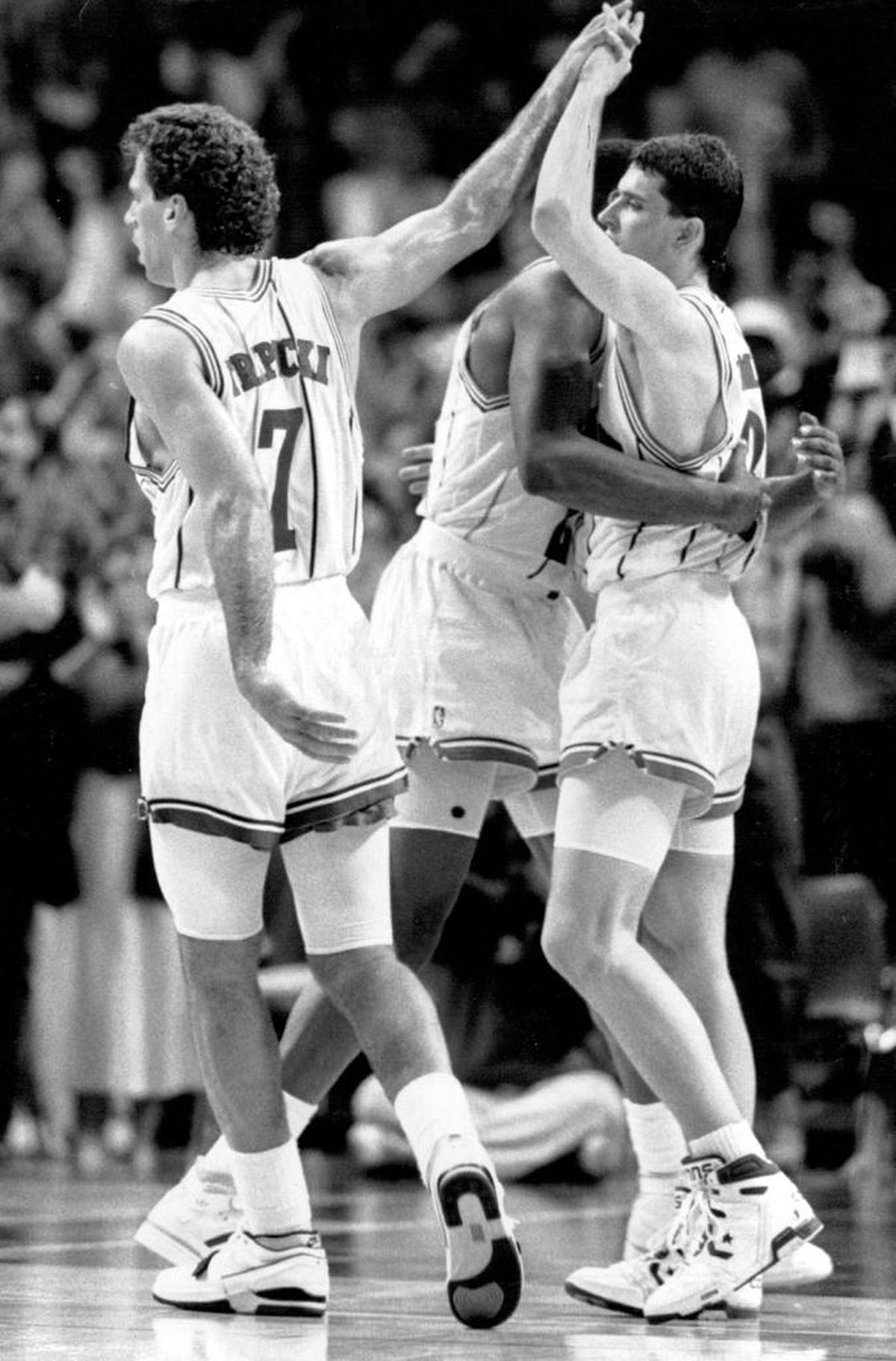 Rex Chapman (right) receives a hug from Earl Cureton and a high-five from Kelly Tripucka (left) after Chapman’s 3-pointer sealed a victory against the then-Washington Bullets in 1989.