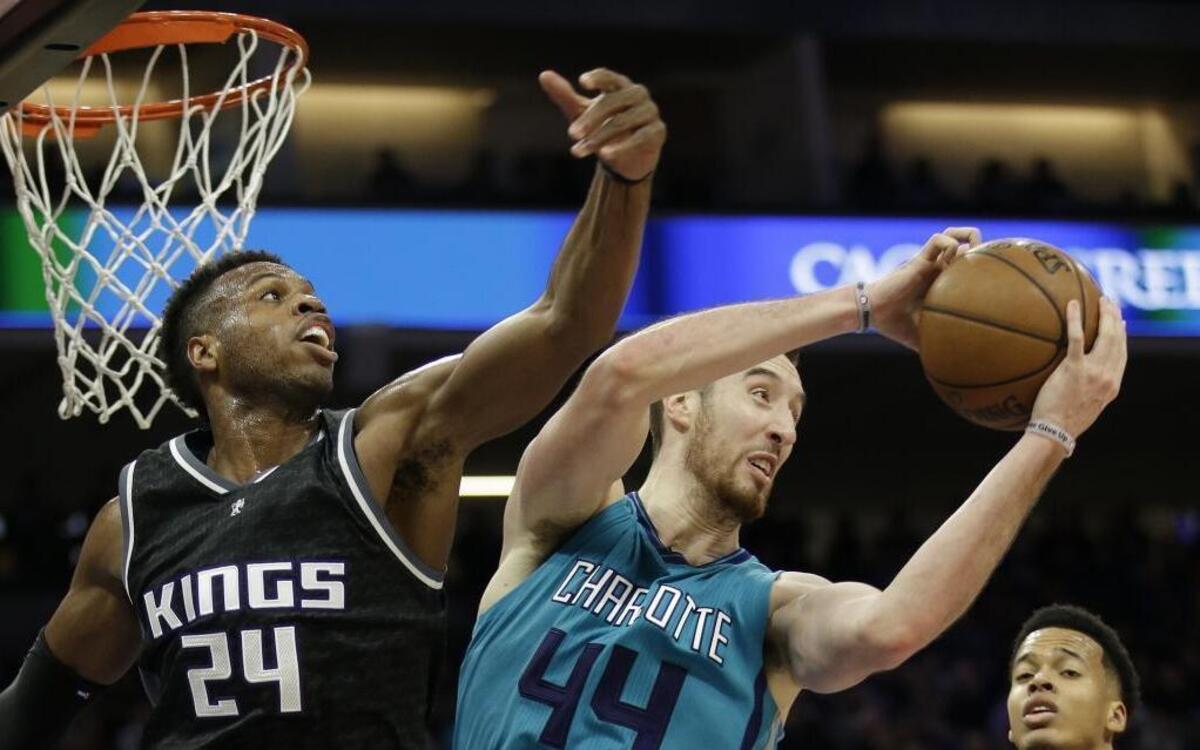 Charlotte Hornets center Frank Kaminsky III, center, grabs a rebound against Sacramento Kings guard Buddy Hield, left, during Saturday’s game.