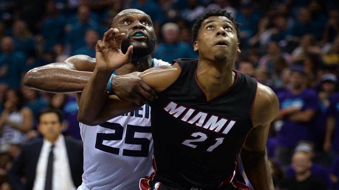 Charlotte Hornets center Al Jefferson, left, battles Miami Heat center Hassan Whiteside, right, under the board during second-half action during Game 6 Friday in Charlotte.
