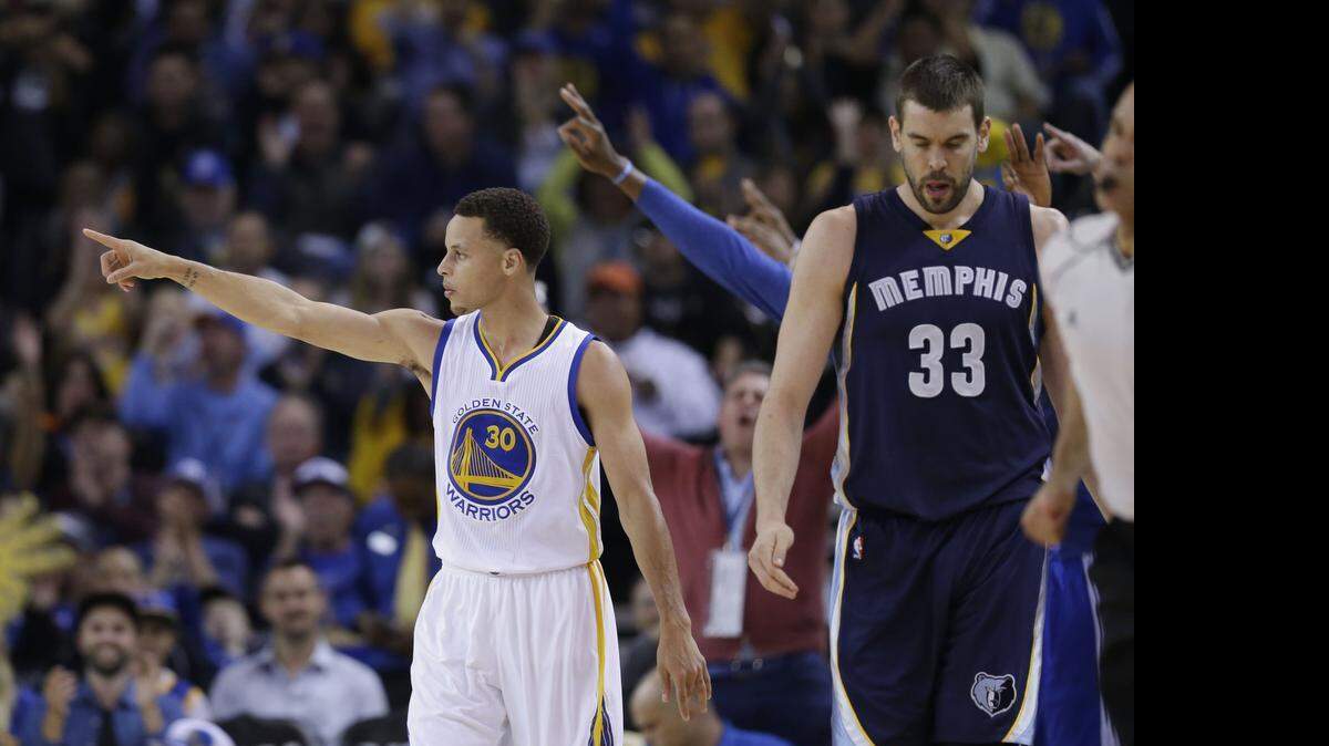 
Golden State Warriors' Stephen Curry points after making a 3-point basket against Memphis.
