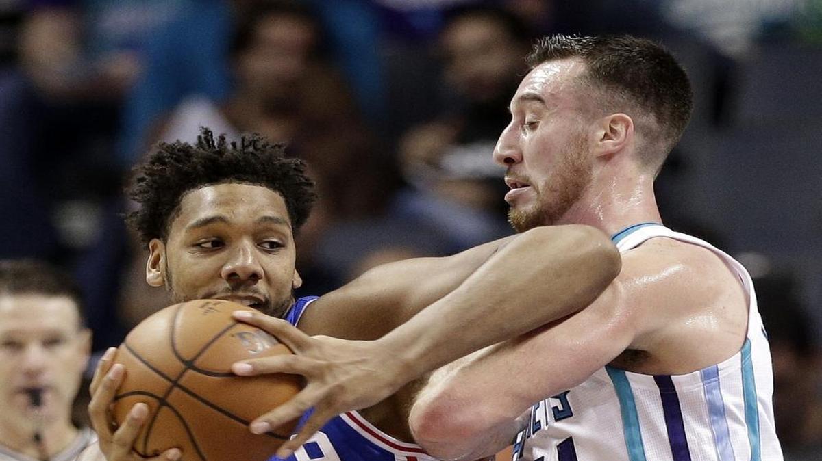 Philadelphia 76ers' Jahlil Okafor, left, drives against Charlotte Hornets' Frank Kaminsky during the first half of Wednesday’s NBA game in Charlotte.