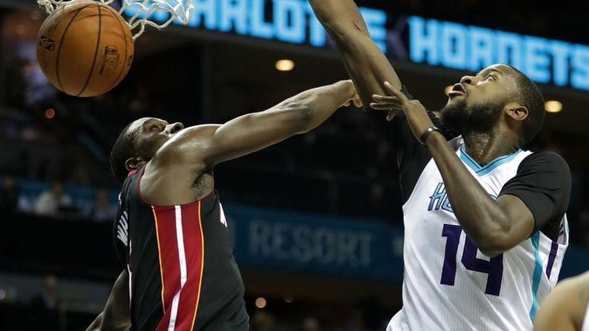 Michael Kidd-Gilchrist dunks the ball over Miami’s Okaro White for two of his 10 points Thursday night during the Hornets’ 96-88 exhibition victory in Charlotte. Kidd-Gilchrist also had 14 rebounds.