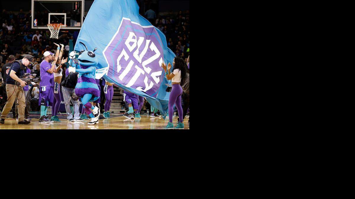 
Charlotte Hornets' mascot Hugo carries the team flag through a line of the Honeybee dance team to get fans inspired during Friday’s game in Charlotte..
