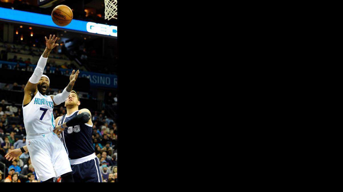 
Charlotte Hornets' Mo Williams (7) flips up a shot over Oklahoma City Thunder's Mitch McGary (33) in the first half at Time Warner Cable Arena on Saturday, Feb. 21, 2015. 
