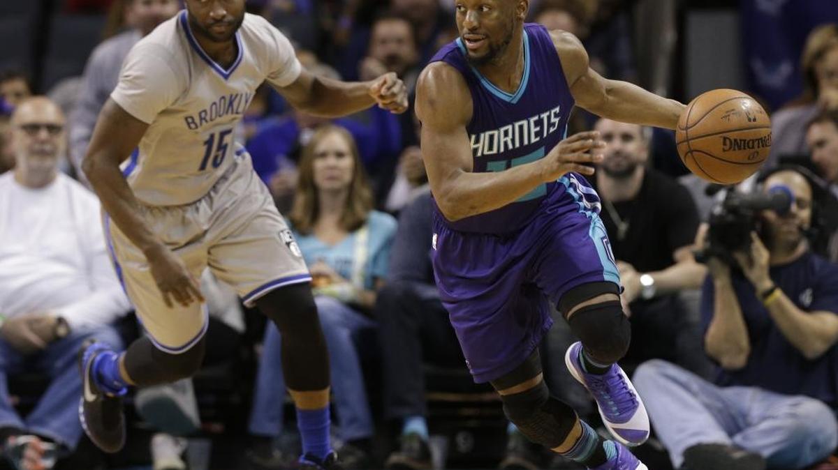 Donald Sloan (left), shown in April 2016 while with the Brooklyn Nets, defends Charlotte’s Kemba Walker. Sloan, who played in China last season, is a possibility to fill the third point guard spot for the Charlotte Hornets.