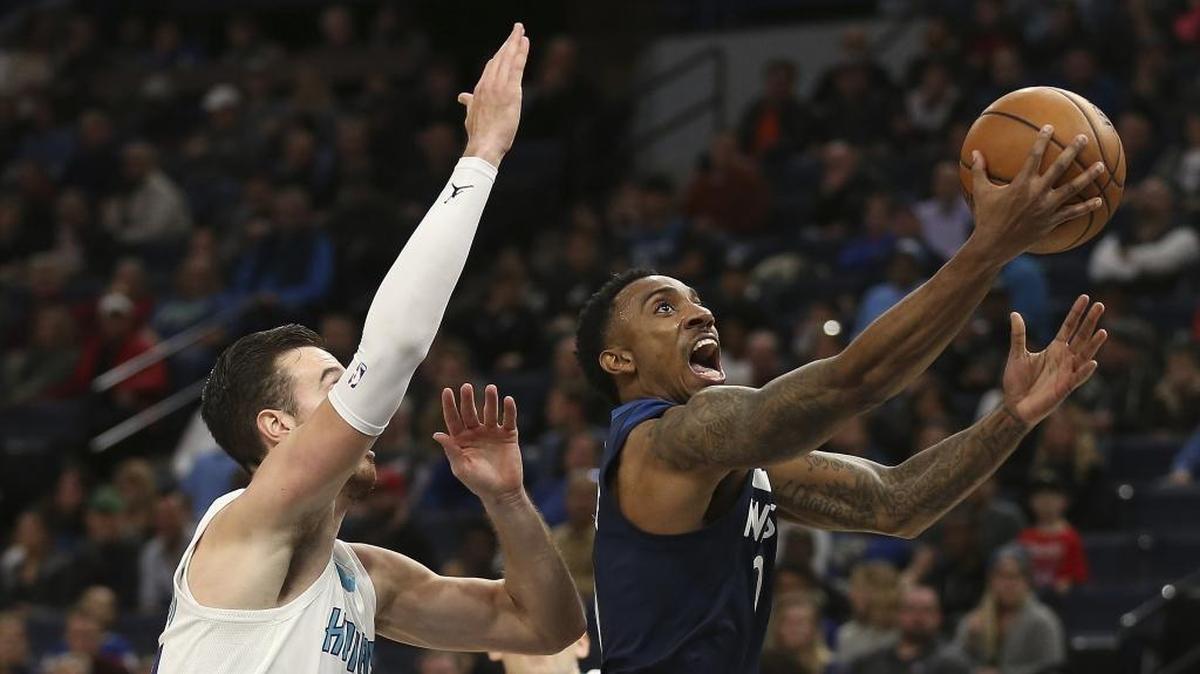Minnesota Timberwolves guard Jeff Teague, right, drives by Charlotte Hornets forward Frank Kaminsky (44) in the first half Sunday night at Target Center. Teague finished with 18 points and 12 assists.