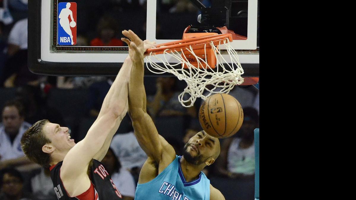 
 Tyler Hansbrough (left), dunks the ball against former Charlotte Hornet Gerald Henderson (right) at Time Warner Cable Arena April 8, 2015. Hansbrough has come to terms with the Hornets.
