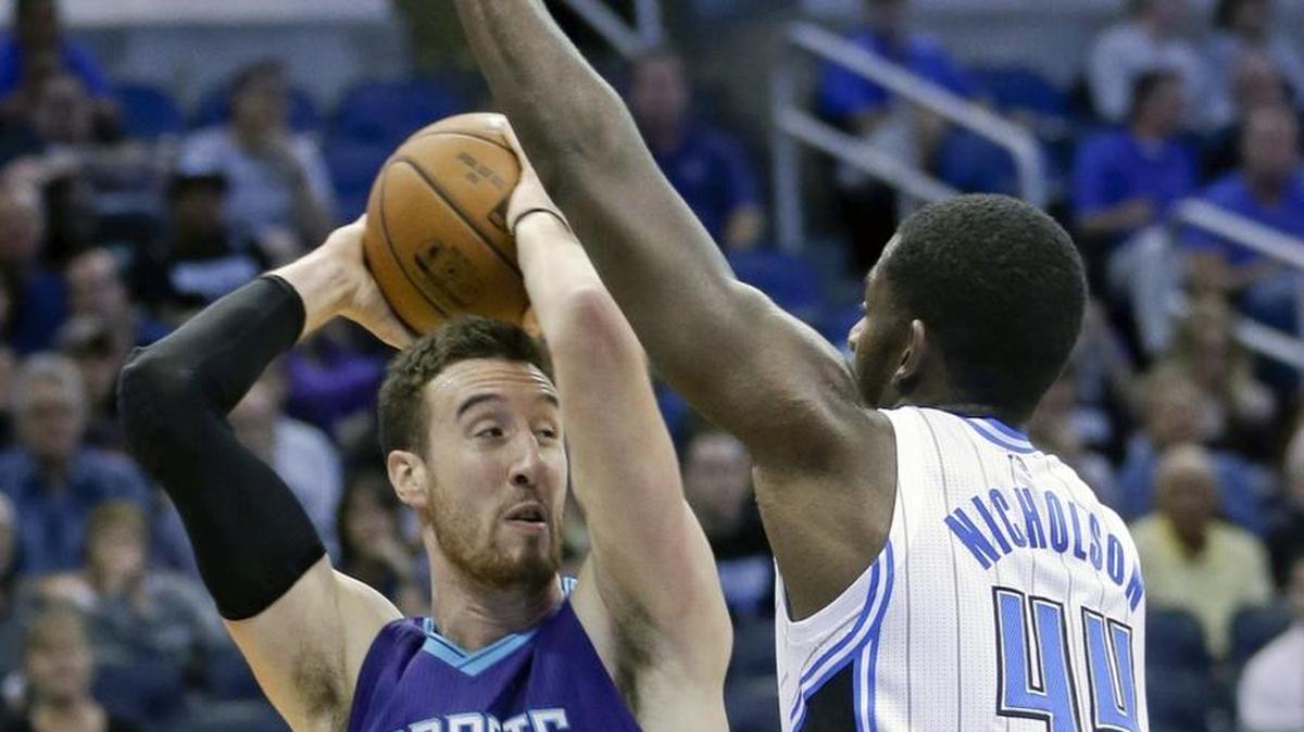 Charlotte Hornets center Frank Kaminsky III, left, looks to pass the ball as Orlando Magic forward Andrew Nicholson defends during the first half of Wednesday’s game in Orlando.