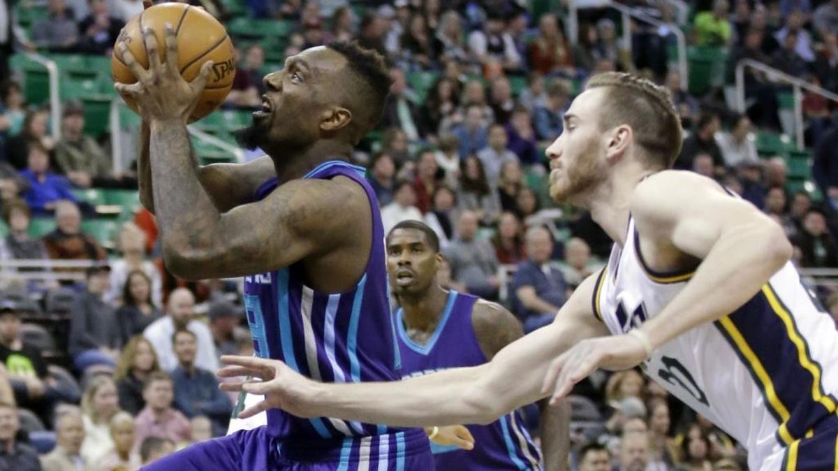 Charlotte Hornets forward P.J. Hairston, left, goes to the basket as Utah Jazz forward Gordon Hayward, right, defends during Wednesday’s game in Salt Lake City.