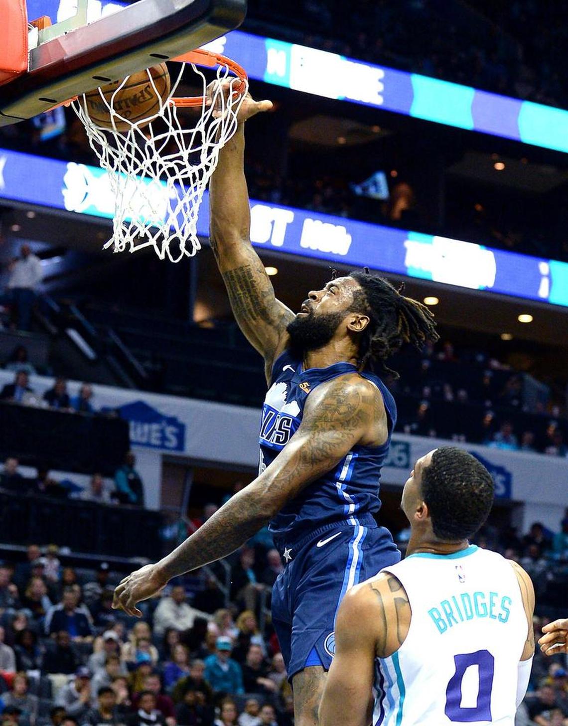 Dallas Mavericks center DeAndre Jordan, left, dunk as Charlotte Hornets forward Miles Bridges looks on during second half of Wednesday night’s NBA game at Spectrum Center.