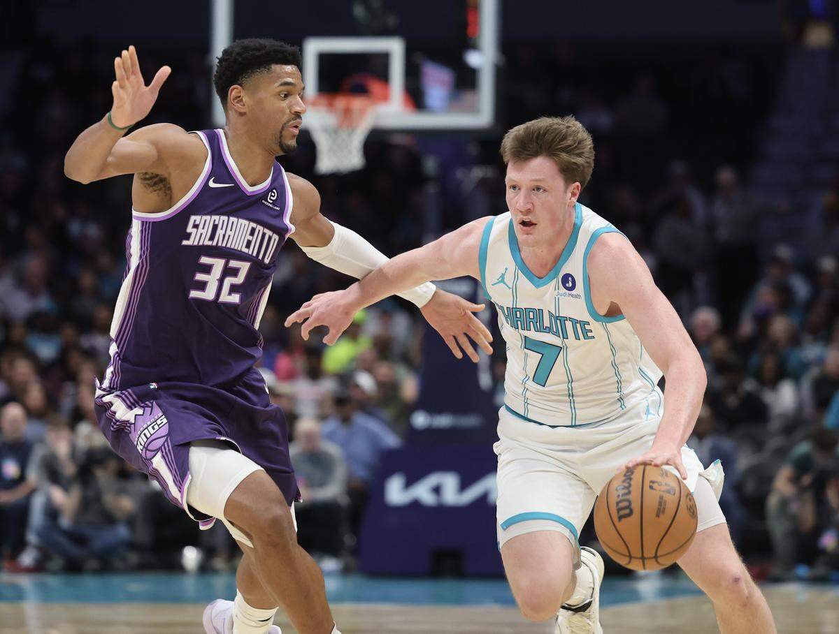 Charlotte Hornets forward Kon Knueppel drives pas Sacramento Kings center Dylan Cardwell during the game on Tuesday, March 24, 2026 at Spectrum Center in Charlotte.