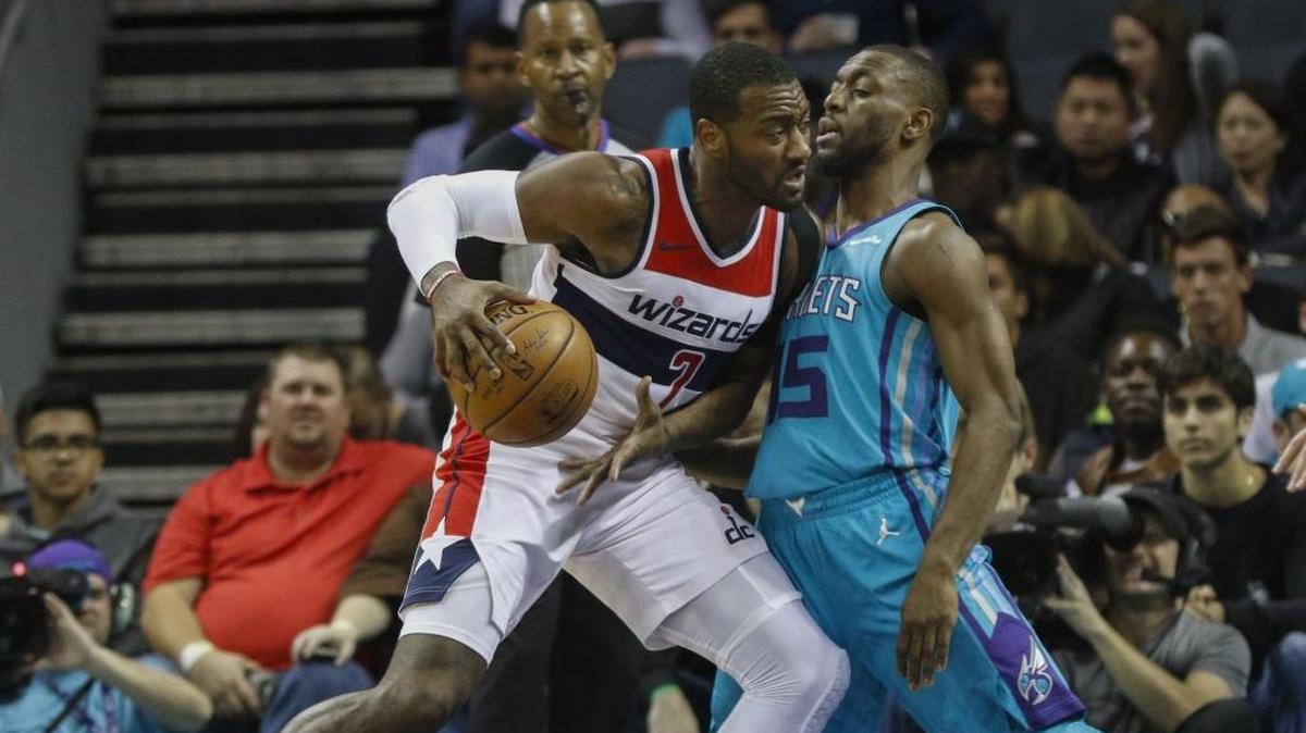 Washington Wizards guard John Wall (left), a Raleigh native, had 31 points and 11 assists against the Hornets in his return to North Carolina on Wednesday night, but it wasn’t enough, as his team lost in overtime.