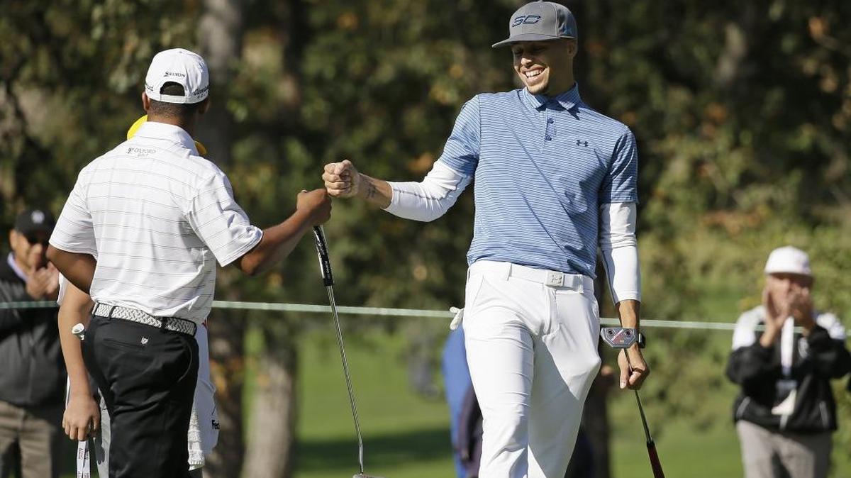 FILE - In this Oct. 12, 2016, file photo, Golden State Warriors' Stephen Curry, right, greets playing partner Harold Varner III, left, on the 14th green of the Silverado Resort North Course during the pro-am event of the Safeway Open PGA golf tournament, in Napa, Calif. Two-time NBA MVP Stephen Curry is set to test his golf game against the pros. The Web.com Tour announced Wednesday, June 28, 2017, that Curry, who recently won his second NBA championship with the Golden State Warriors, will play in the Ellie Mae Classic. The event at TPC Stonebrae runs from Aug. 3-6. (AP Photo/Eric Risberg, File)