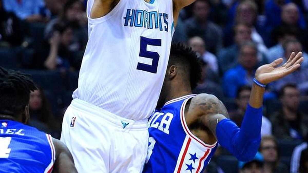 Hornets guard Nic Batum slices between two Philadelphia 76ers for a shot during the first half the Spectrum Center in Charlotte on Monday night.