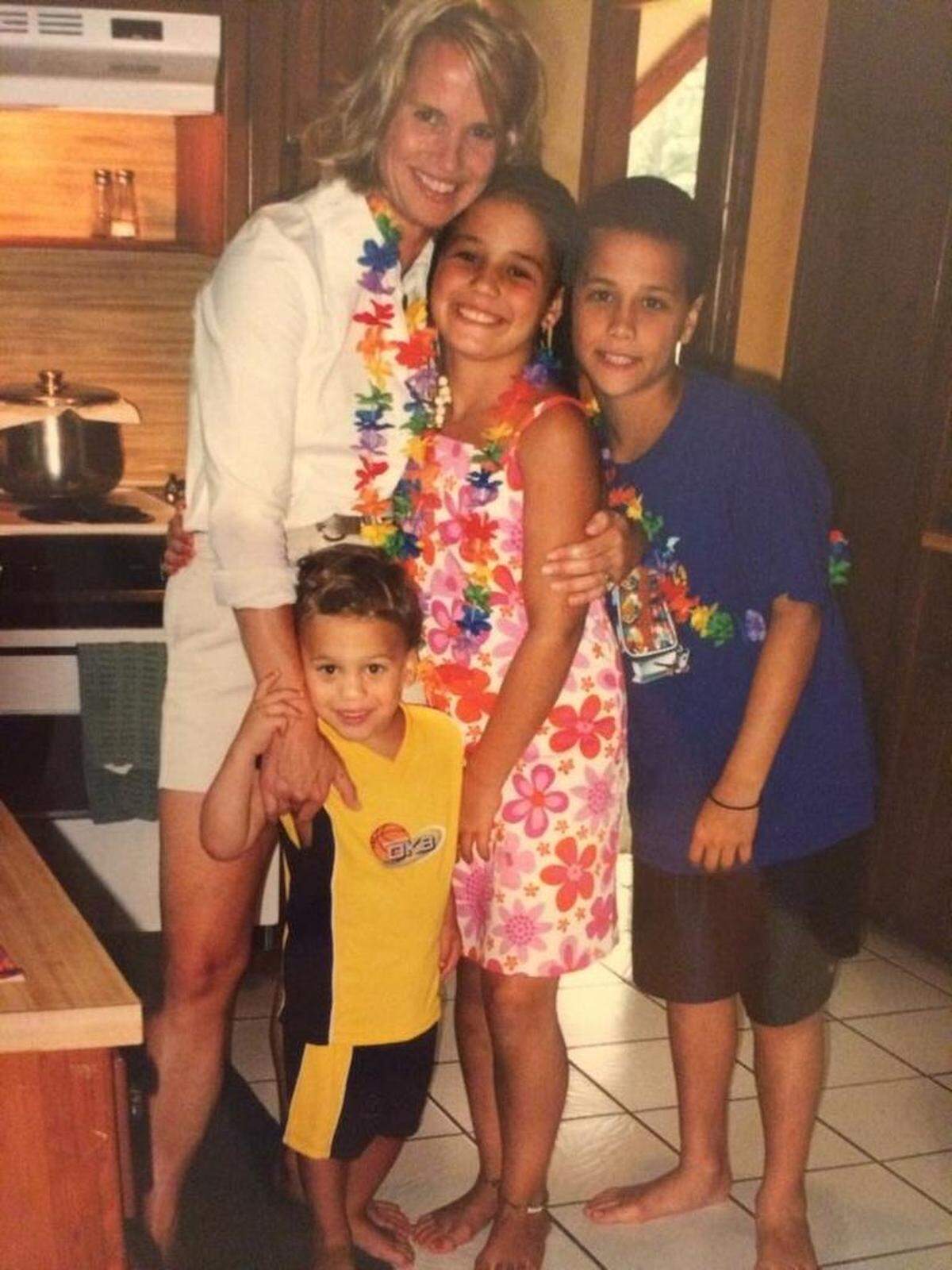 Ashley ShahAhmadi with her mom Cheryl and her brothers Aryon (right) and Brandon (down in front), around the time Ashley went to her first NBA game.