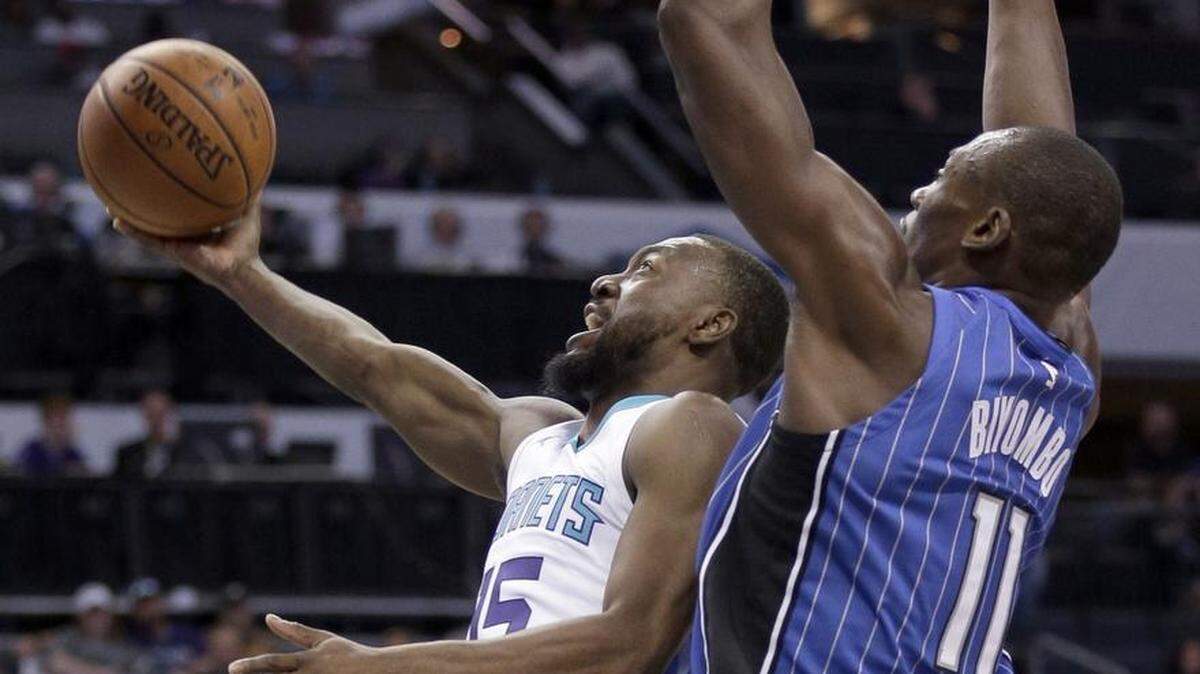 Charlotte Hornets' Kemba Walker (15) drives past Orlando Magic's Bismack Biyombo (11) Sunday at Spectrum Center.