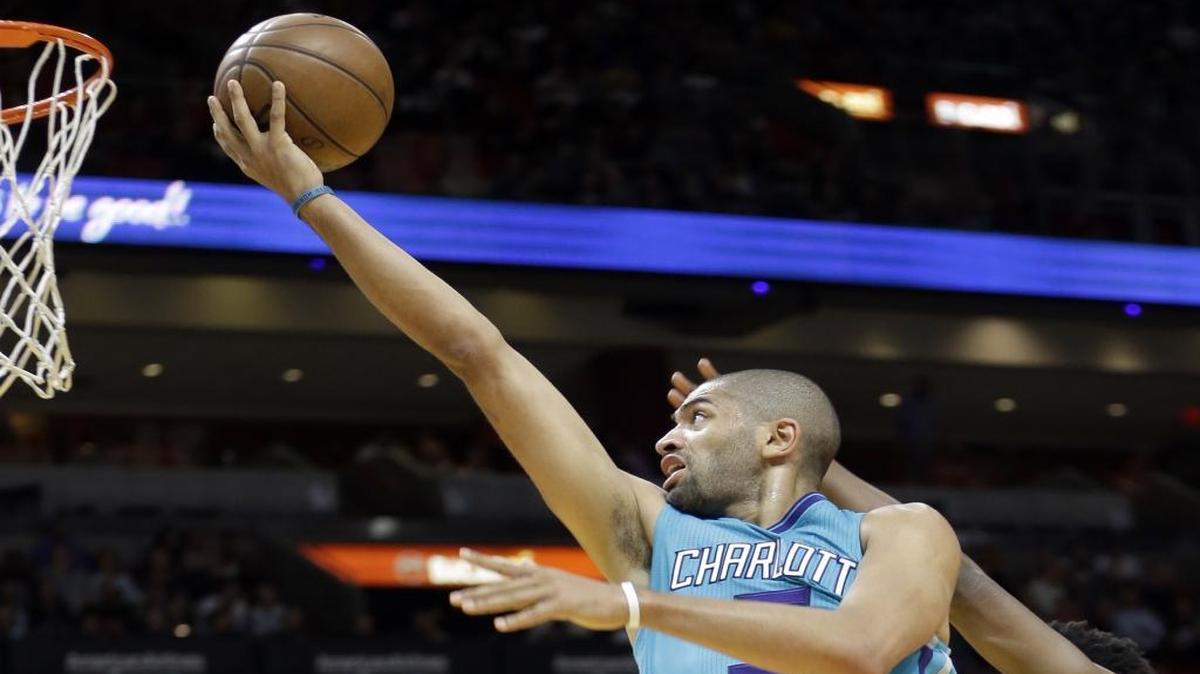 Charlotte Hornets guard Nicolas Batum (5) goes to the basket as Miami Heat guard Josh Richardson (0) defends in Wednesday’s game in Miami.