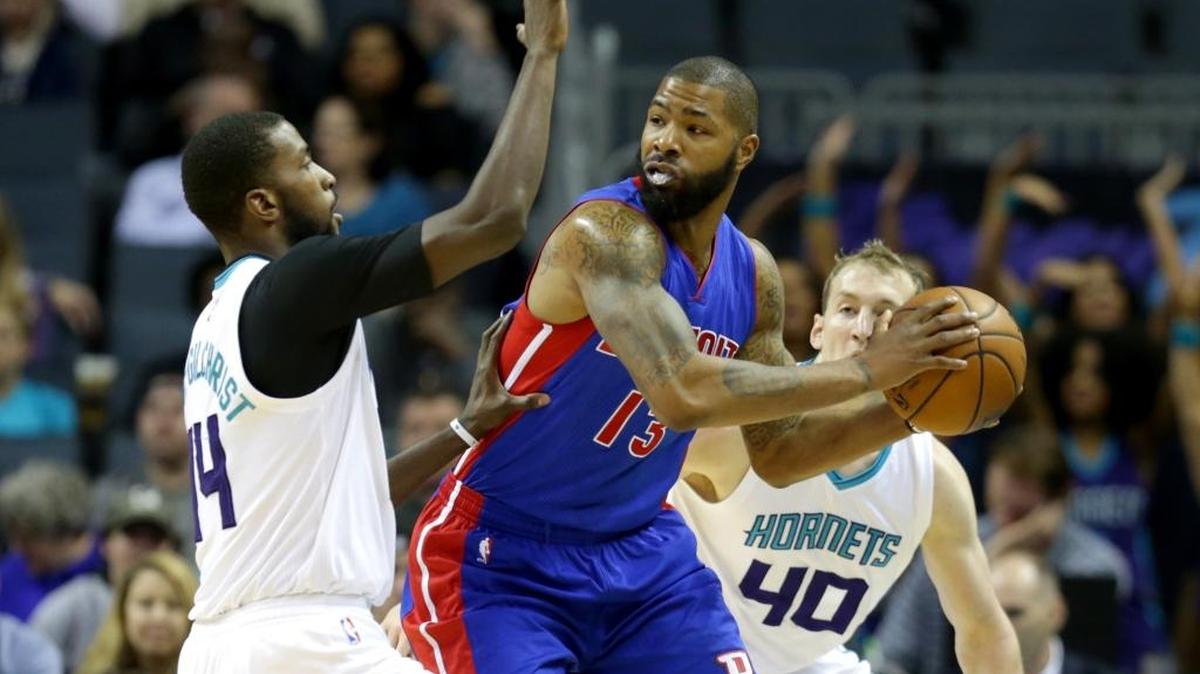 Marcus Morris of the Detroit Pistons is double-teamed by Charlotte Hornets Michael Kidd-Gilchrist and Cody Zeller (40) during Tuesday night’s game at Spectrum Center in Charlotte.