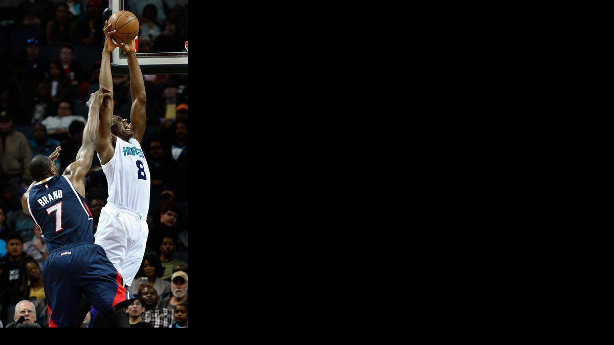 
Charlotte Hornets Bismack Biyombo, right fights to get a shot off near the goal as Atlanta Hawks Elton Brand, left, applies defensive pressure at Time Warner Cable Arena in Charlotte, NC on Saturday, March 28, 2015. 
