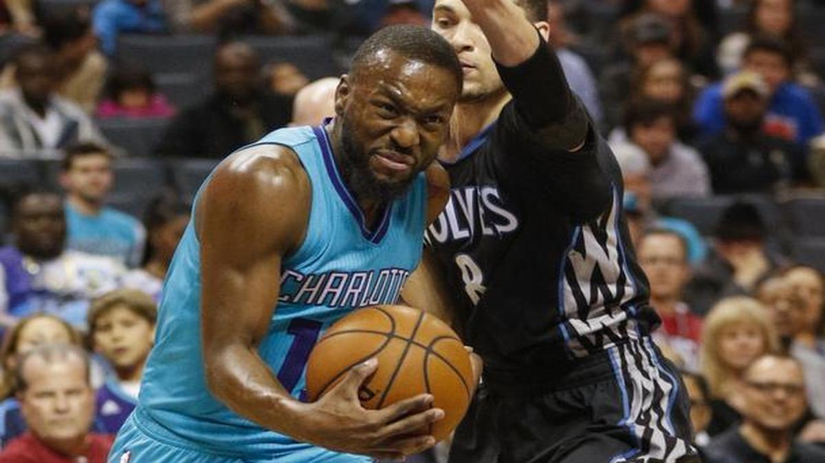 Charlotte Hornets guard Kemba Walker, left, drives past Minnesota Timberwolves guard Zach LaVine in the first half of Saturday’s game.