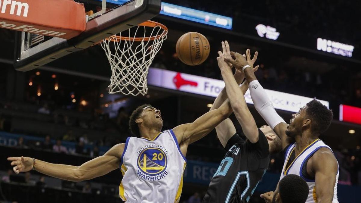 Charlotte Hornets forward Tyler Hansbrough, center, fights Golden State Warriors forward James Michael McAdoo, left, and forward Jason Thompson for a rebound on Wednesday. Golden State won 116-99.