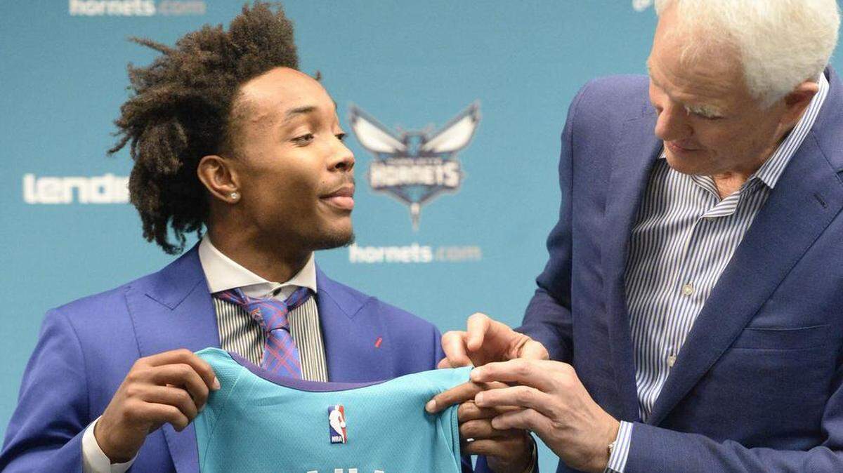 Charlotte Hornets general manager Mitch Kupchak (right) traded two future second-round picks to the Atlanta Hawks to move up to the 34th pick and select Kansas point guard Devonte Graham.